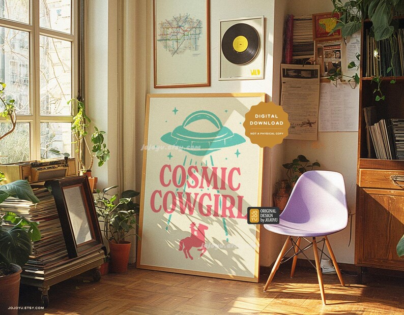 May include: A digital download print featuring a pink and blue illustration of a UFO with stars and the text "Cosmic Cowgirl".