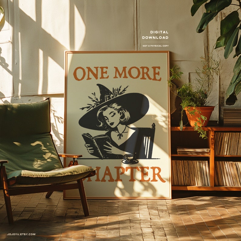 May include: A digital download print featuring a black and white illustration of a witch reading a book with the text "One More Chapter". The witch is wearing a black hat and dress and is sitting in a chair. The background is a light beige color.