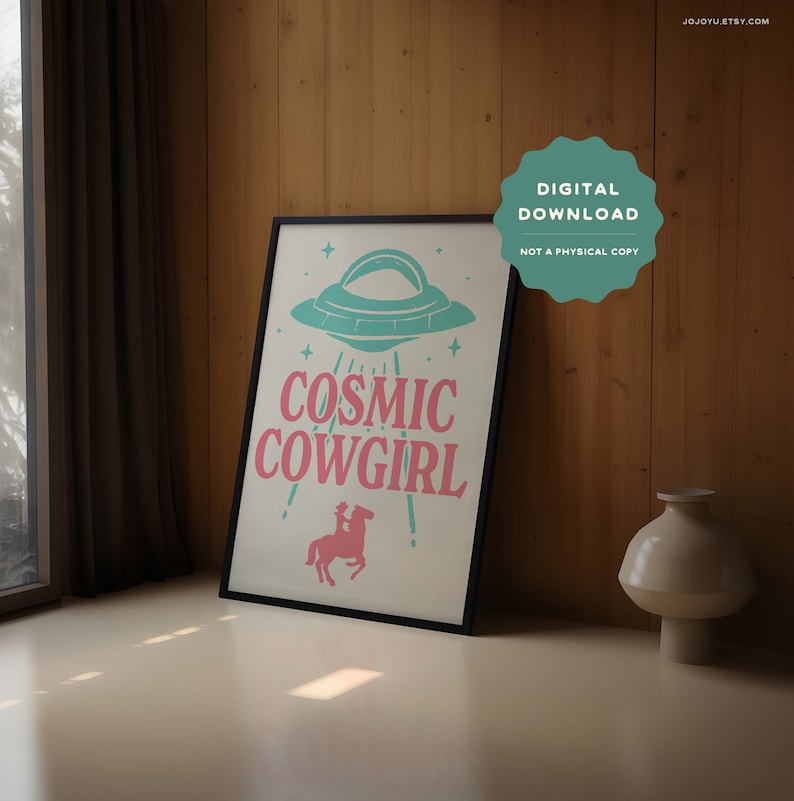 May include: A digital download print featuring a pink and teal graphic of a cowgirl riding a horse with a UFO above her. The text "Cosmic Cowgirl" is written in pink and teal letters.