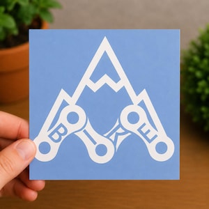 May include: A square light blue sticker featuring a white graphic of a mountain peak formed by bicycle chain links. The letters B, I, K, and E are integrated into the individual chain link segments, creating a stylised mountain and bike design.