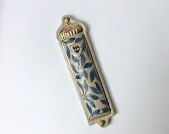 Handmade ceramic mezuzah case decorated with handpainted blue floral motifs and gold