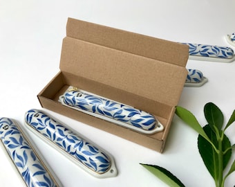 Porcelain Mezuzah case, handpainted with blue and gold, with brass screws