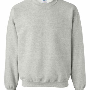 May include: A gray crewneck sweatshirt with a small tag on the front that says "Gildan" in blue.
