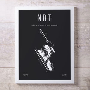 May include: A framed black and white print featuring a detailed map of Narita International Airport. The print includes the airport code "NRT" at the top, with "Narita International Airport" below. The words "Tokyo" and "Japan" are at the bottom.