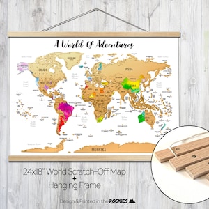 May include: A 24x18 inch gold world scratch-off map with a wooden hanging frame. The map features colorful countries and the text "A World of Adventures".