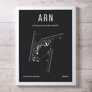 May include: Black and white airport map print with the text "ARN" and "Stockholm Arlanda Airport" in a white sans-serif font. The map shows the layout of the airport with runways, taxiways, and terminals. The text "Stockholm, Uppland" and "Sweden" are also included in the print.