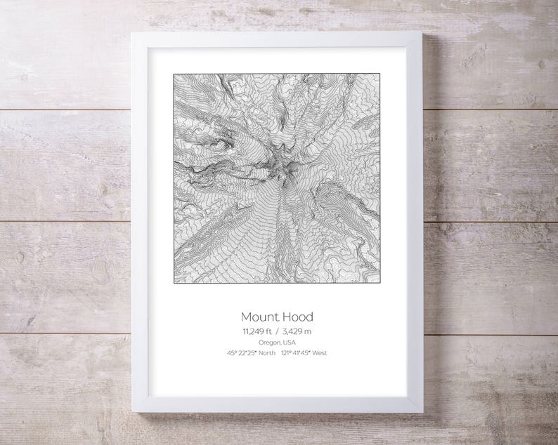 May include: A black and white topographic map print of Mount Hood, Oregon, USA. The print shows the mountain's elevation contours and includes the mountain's name, elevation, and location.