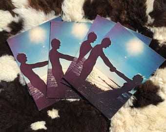 May include: Four vintage record covers with a blue and white sky background. The covers feature silhouettes of people holding hands and walking towards the horizon.