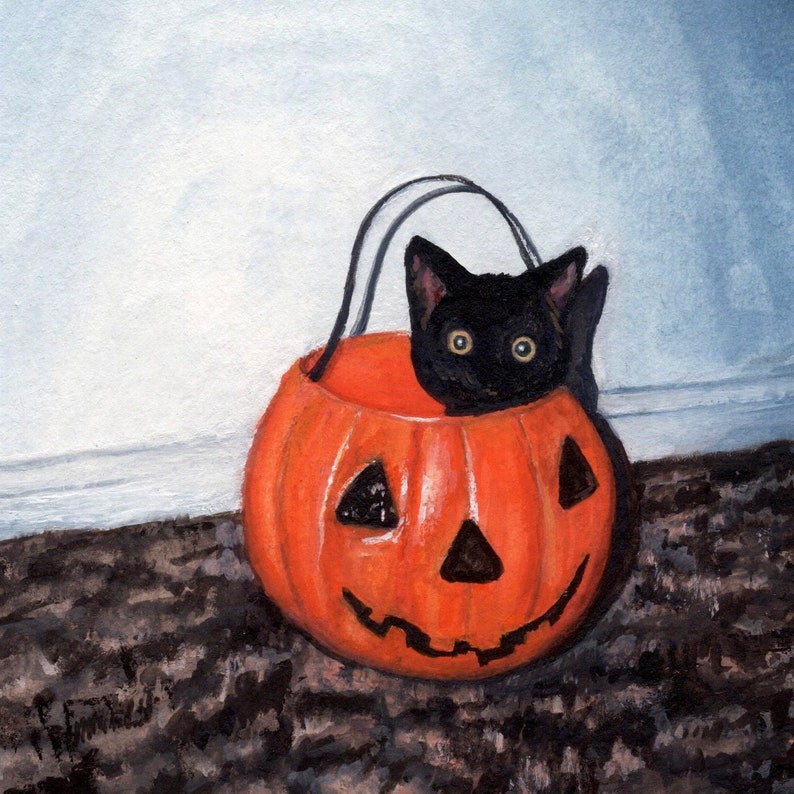 May include: A black kitten peeking out of an orange jack-o'-lantern with a carved face. The pumpkin is sitting on a brown and black patterned surface.