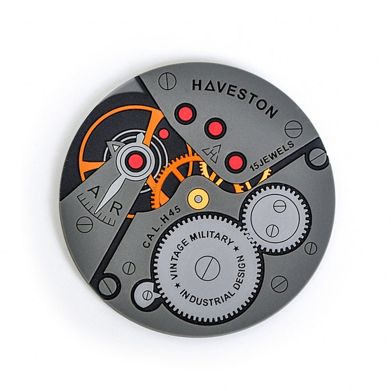 Puede incluir: Primer plano de una esfera de reloj gris con detalles en naranja y rojo. La esfera del reloj muestra el texto "HAVESTON 15 JEWELS" y "CAL. H45 VINTAGE MILITARY INDUSTRIAL DESIGN".
