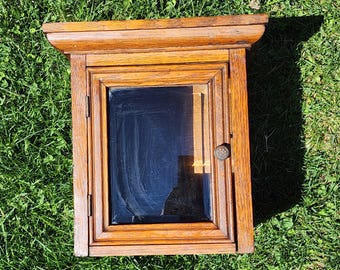 Armario antiguo para pipa de tabaco con puerta de cristal biselado de madera, década de 1900.