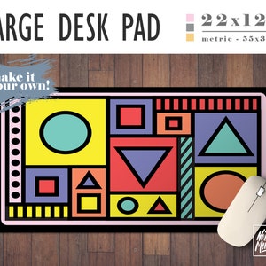 May include: A large desk pad with a geometric design featuring circles, squares, and triangles in various colors, including yellow, red, blue, green, and orange. The pad is 22 inches by 12 inches and has the text "make it your own!" in a gray box on the top left corner.
