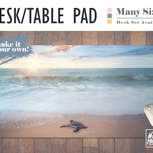 May include: A desk or table pad featuring a scenic beach scene with a sea turtle on the sand. The sky is a soft blue with pink and orange hues. The text "make it your own!" is in a gray box at the top left corner. The text "No Bad Mondays" is in the bottom right corner.