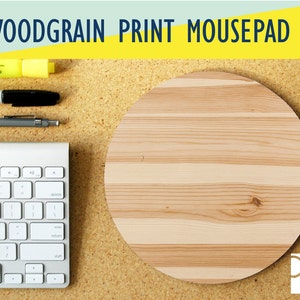 May include: A round woodgrain print mousepad with a light brown and beige woodgrain pattern. The mousepad is on a corkboard surface.