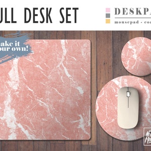 May include: A pink marble desk pad set with a matching mousepad and coaster. The desk pad has a white marble pattern and the text "make it your own!" in a blue brushstroke. The mousepad and coaster have the text "No Bad Mondays" in black.