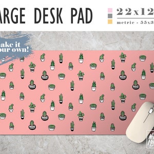 May include: A large desk pad with a pink background featuring a pattern of green potted cacti. The pad measures 22x12 inches. The text "LARGE DESK PAD" and "make it your own!" are displayed on the pad. A white computer mouse is on the right.