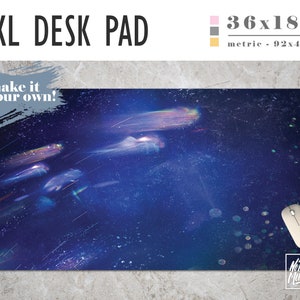 May include: A large, blue desk pad with a galaxy-like design featuring streaks of light and a subtle sparkle effect. The pad measures 36x18 inches and has the text "make it your own!" in the top left corner.