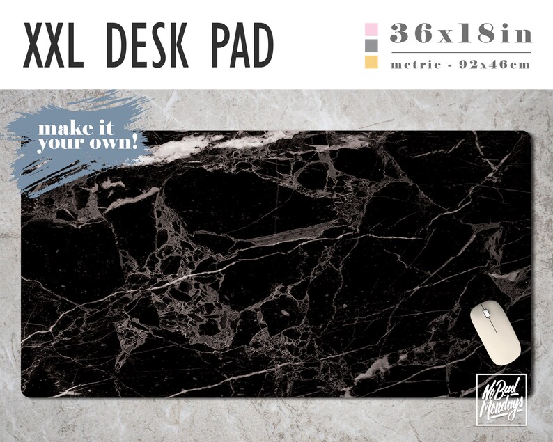 May include: Black marble desk pad with a white marble pattern. The pad measures 36x18 inches. The text "make it your own!" is in a white box on the top left corner of the pad. A computer mouse is on the bottom right corner of the pad.