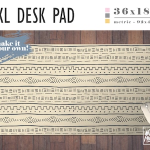 May include: A large beige desk pad with a geometric pattern in black. The pad measures 36 inches by 18 inches, or 92 centimeters by 46 centimeters. The text "make it your own!" is written in blue on a gray background in the top left corner. The text "No Bad Mondays" is written in white on a black background in the bottom right corner.