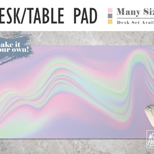 May include: A desk or table pad with a holographic iridescent design in shades of pink, purple, and green. The text "make it your own!" is in the top left corner. The text "No Bad Mondays" is in the bottom right corner. The pad is available in multiple sizes and as a desk set.