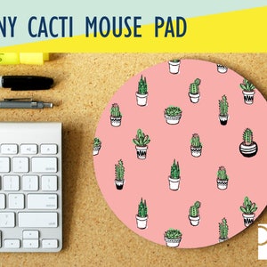 May include: A round pink mouse pad with a repeating pattern of green cacti in white pots. The text "TINY CACTI MOUSE PAD" is at the top of the image.