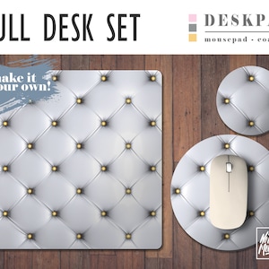 May include: A full desk set with a large white desk pad, a round mousepad, and a round coaster. All three items feature a tufted design with gold buttons and the text "No Bad Mondays".