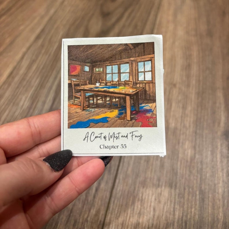 May include: A drawing of a room with a table and chairs, with paint splattered on the floor. The drawing is from the book "A Court of Mist and Fury", Chapter 55.