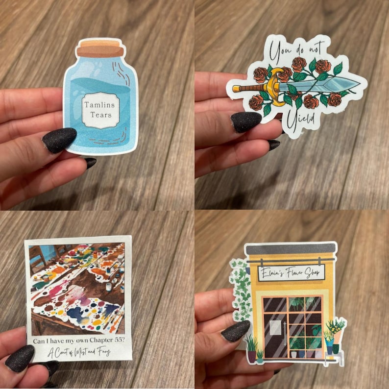 May include: Four different stickers featuring a blue glass bottle with the text "Tamlins Tears", a sword with roses and the text "You do not yield", a colorful paint splattered table with the text "Can I have my own Chapter 55? A Court of Mist and Fury", and a yellow building with the text "Elara's Flower Shop".