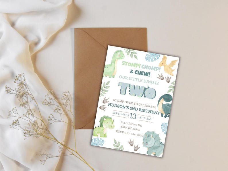 May include: A dinosaur-themed birthday invitation with the text "STOMP! CHOMP! & CHEW! OUR LITTLE DINO IS TWO." The invitation includes illustrations of dinosaurs and foliage, with the date and time of the party. A brown envelope is behind the invitation.