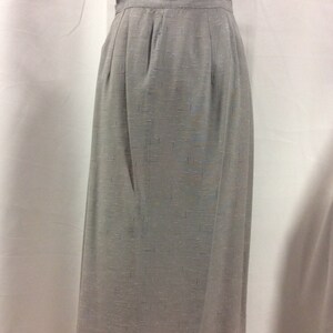 May include: A grey skirt with a subtle shimmer, featuring a straight silhouette and a simple design.