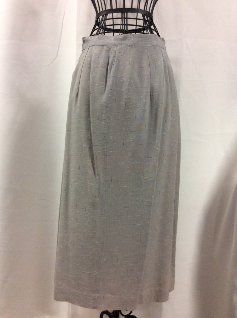 May include: A grey skirt with a subtle shimmer, featuring a straight silhouette and a simple design.