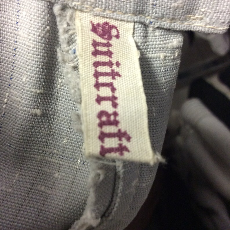 May include: A close-up of a white fabric tag with the word "Suttera" printed in purple.