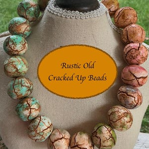 May include: A necklace featuring round beads with a cracked texture, displaying a gradient of turquoise, green, and peach tones. An oval orange graphic in the center contains the black text: Rustic Old Cracked Up Beads. The beads are arranged in a circular pattern.