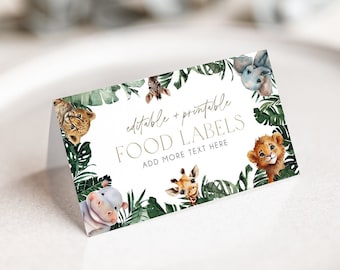 May include: Editable and printable food labels with a jungle theme. The labels feature a circle of cartoon animals including a lion, giraffe, elephant, hippopotamus, and monkey. The text on the label reads "Editable & Printable Food Labels" and "Add More Text Here".