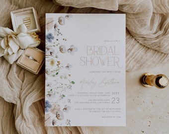 May include: A white bridal shower invitation with a floral design featuring blue, pink, and yellow flowers. The invitation text reads "Join us for a Bridal Shower honoring the bride-to-be Aisley Smithson Saturday, August 23rd, 20XX Sept 23 from 1-4 o'clock in the afternoon The Smithson Home 100 Wantirna Road, California Kindly respond by the 1st of September to Ainsley on 555-555-5555 registered or shop"