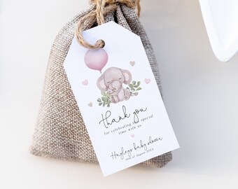 May include: A pink and brown elephant with a pink balloon, holding a smaller elephant. The tag says "Thank you for celebrating this special time with us.  Haylee's baby shower 18th of August 2023"