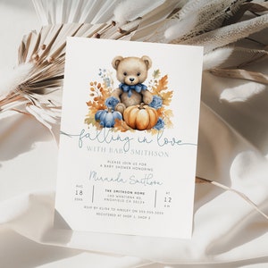 May include: A baby shower invitation featuring a watercolour illustration of a teddy bear holding a pumpkin. The invitation reads "falling in love with baby Smithson" and includes details for the shower.