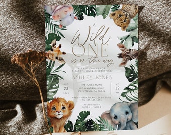 May include: A baby shower invitation with a jungle theme. The invitation features a watercolor illustration of a lion, elephant, giraffe, cheetah, and hippo. The text reads "A Wild One is on the way" and includes the date, time, and location of the shower.
