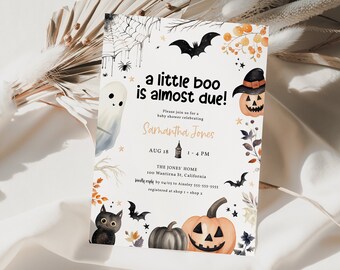 May include: A Halloween-themed baby shower invitation featuring a black and white ghost, a black cat, and a jack-o'-lantern. The invitation reads "a little boo is almost due!" and includes the name "Samantha Jones", the date "AUG 18", the time "1-4 PM", the location "THE JONES HOME 100 Wastirna St, California", and the RSVP details.