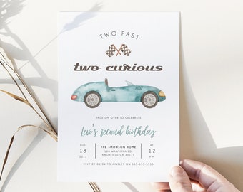 May include: A blue and white birthday invitation with a cartoon car and the text "TWO FAST two curious Levi's second birthday"  The invitation includes the date, time, and location of the party.