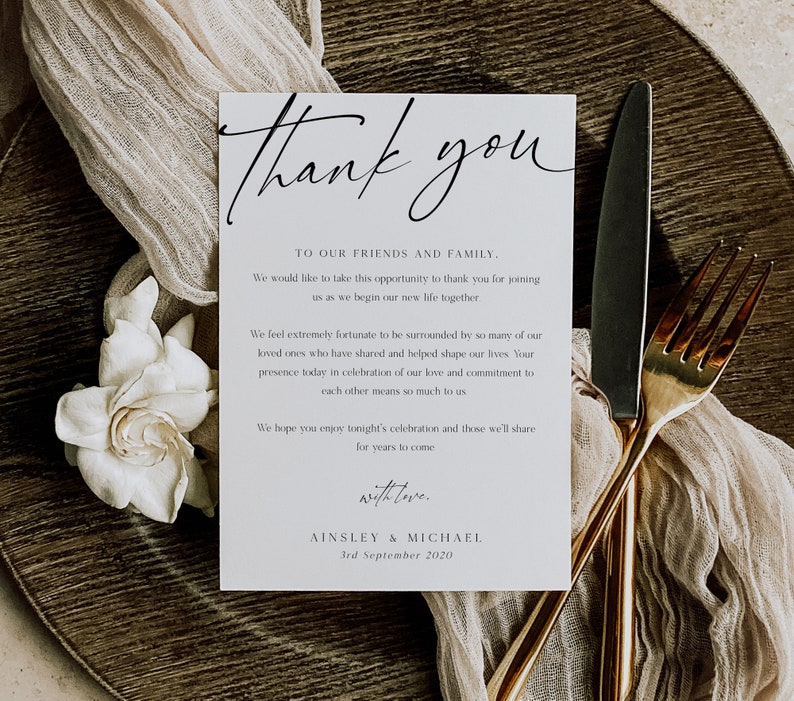 May include: A white thank you card with black calligraphy that reads "Thank you". The card has a simple design with the text "To our friends and family" and a message expressing gratitude for joining the couple as they begin their new life together. The card is signed "Ainsley & Michael" and dated "3rd September 2020".