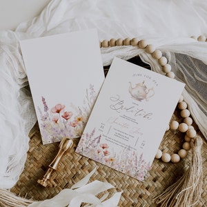 May include: A watercolor floral design with a teapot and the text "Time for Tea" and "Bride-to-be" with the name "Samantha Jones" on a white background. The text "The Hemingway Home" and "August 23, 2021 at 12 PM" is also included.