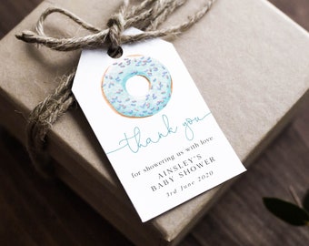 May include: A white thank you tag with a blue and pink donut illustration. The text reads "thank you for showering us with love. Ainsley's Baby Shower 3rd June 2020."