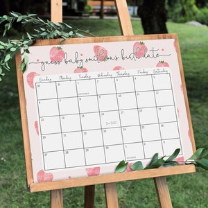 Puede incluir: Un calendario rosa y blanco con un patr&oacute;n de fresas. El calendario se titula "adivina la fecha de nacimiento del beb&eacute; Smithson".