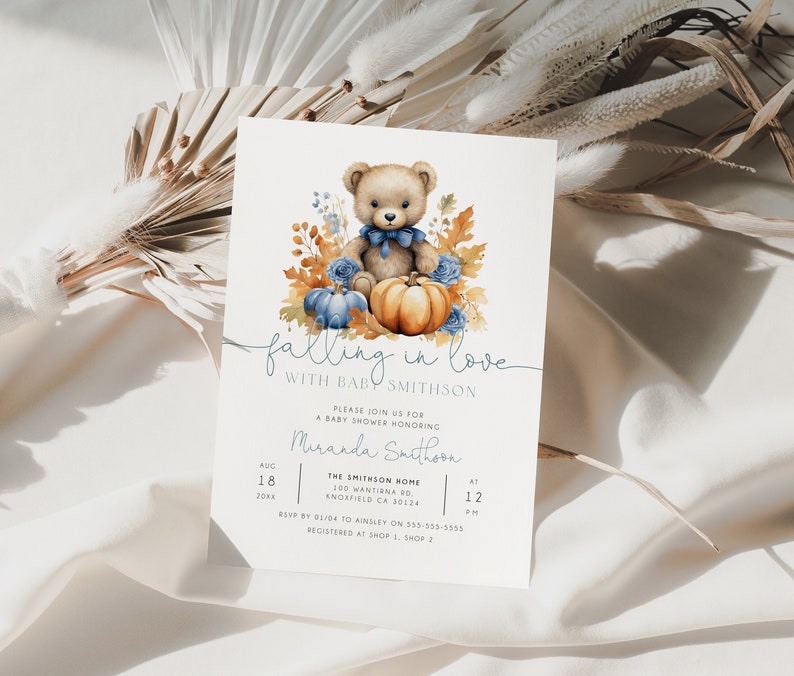 May include: A baby shower invitation featuring a watercolour illustration of a teddy bear holding a pumpkin. The invitation reads "falling in love with baby Smithson" and includes details for the shower.