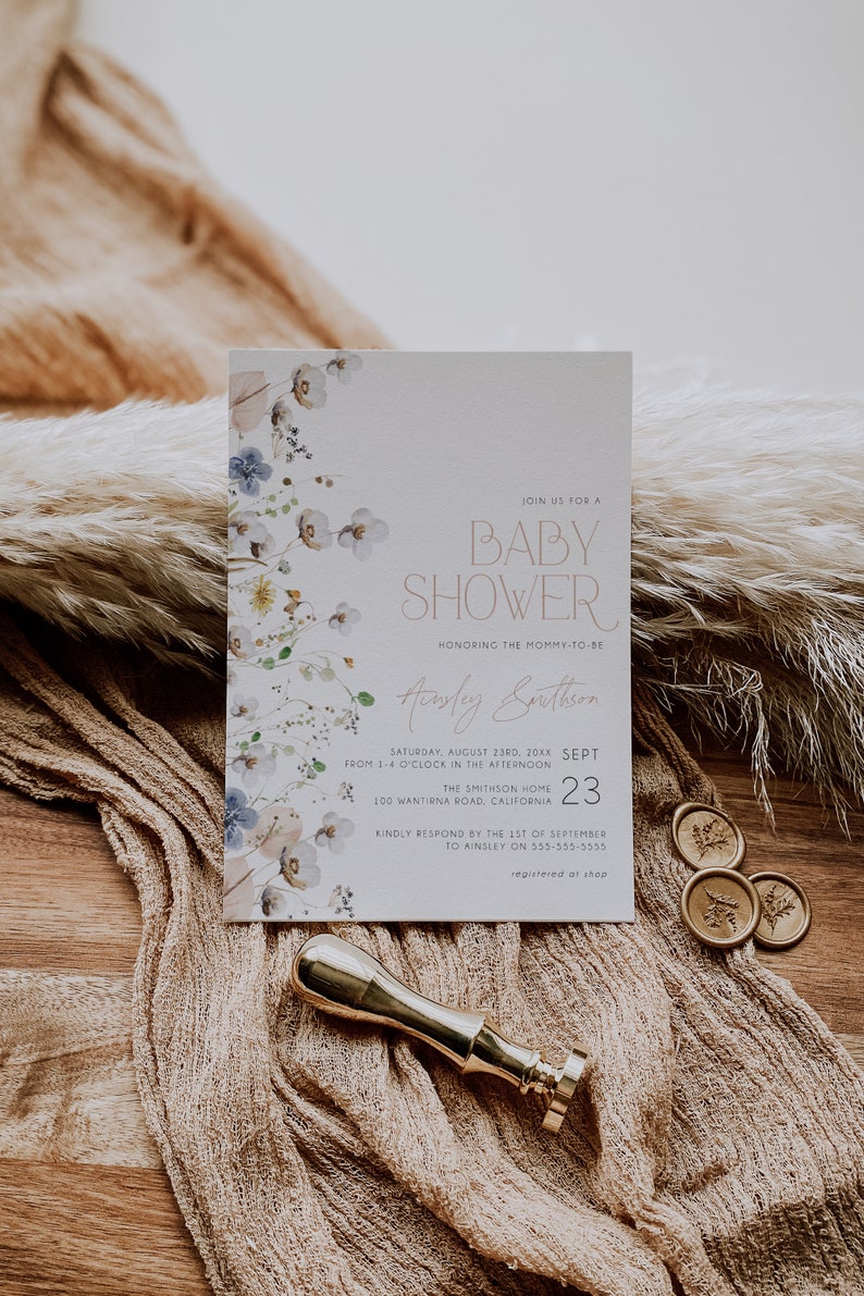 May include: A white baby shower invitation with a floral border. The invitation reads "Join us for a Baby Shower honoring the mommy-to-be Ainsley Smithson, Saturday, August 23rd, 20XX, from 1-4 o'clock in the afternoon, The Smithson Home, 100 Wantrina Road, California, Sept 23, Kindly respond by the 1st of September to Ainsley on 555-555-5555, registered at shop."