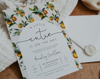 May include: A white baby shower invitation with a watercolor illustration of orange blossoms and the text "A Little Cutie Is On The Way". The invitation includes the date, time, and location of the shower, as well as the name of the guest of honor, Ainsley Smithoon.