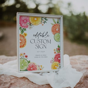 May include: Editable custom sign with a white background and a border. The sign is decorated with watercolor illustrations of citrus fruits, flowers, and leaves. The text on the sign reads "editable custom sign 5x7" + 8x10" create as many signs as you need".