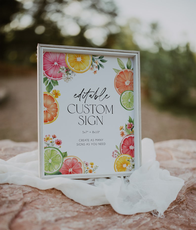 May include: Editable custom sign with a white background and a border. The sign is decorated with watercolor illustrations of citrus fruits, flowers, and leaves. The text on the sign reads "editable custom sign 5x7" + 8x10" create as many signs as you need".