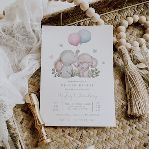 May include: A gender reveal invitation with a watercolor illustration of two elephants holding pink and blue balloons. The text reads "Please join us for a Gender Reveal honoring the parents-to-be Hayley & Zachary. Aug 18, 20XX at 12 PM. The Smithson Home 100 Wantirna Rd Knuxfield CA 30124. RSVP by 01/04 to Hayley on 555-555-5555. Registered at Shop 1, Shop 2, Shop 3."